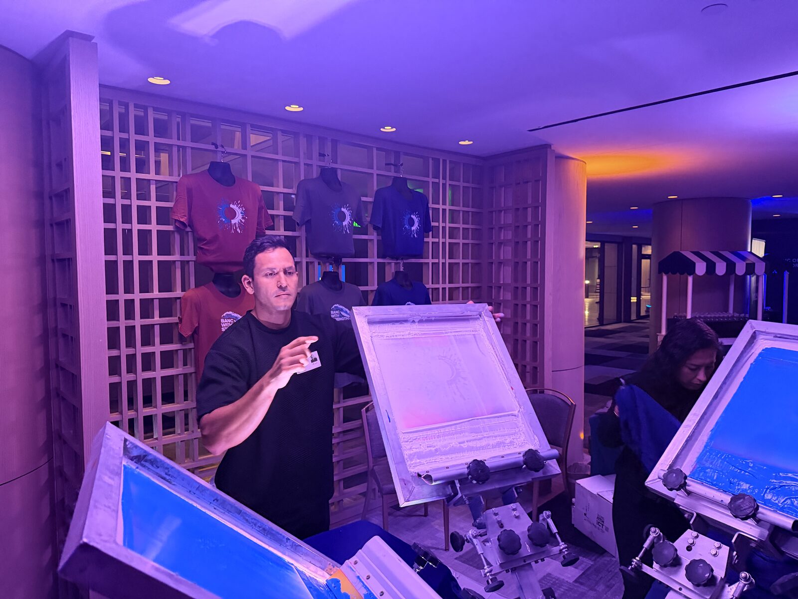 Row of screen printing presses glowing at an evening wedding reception
