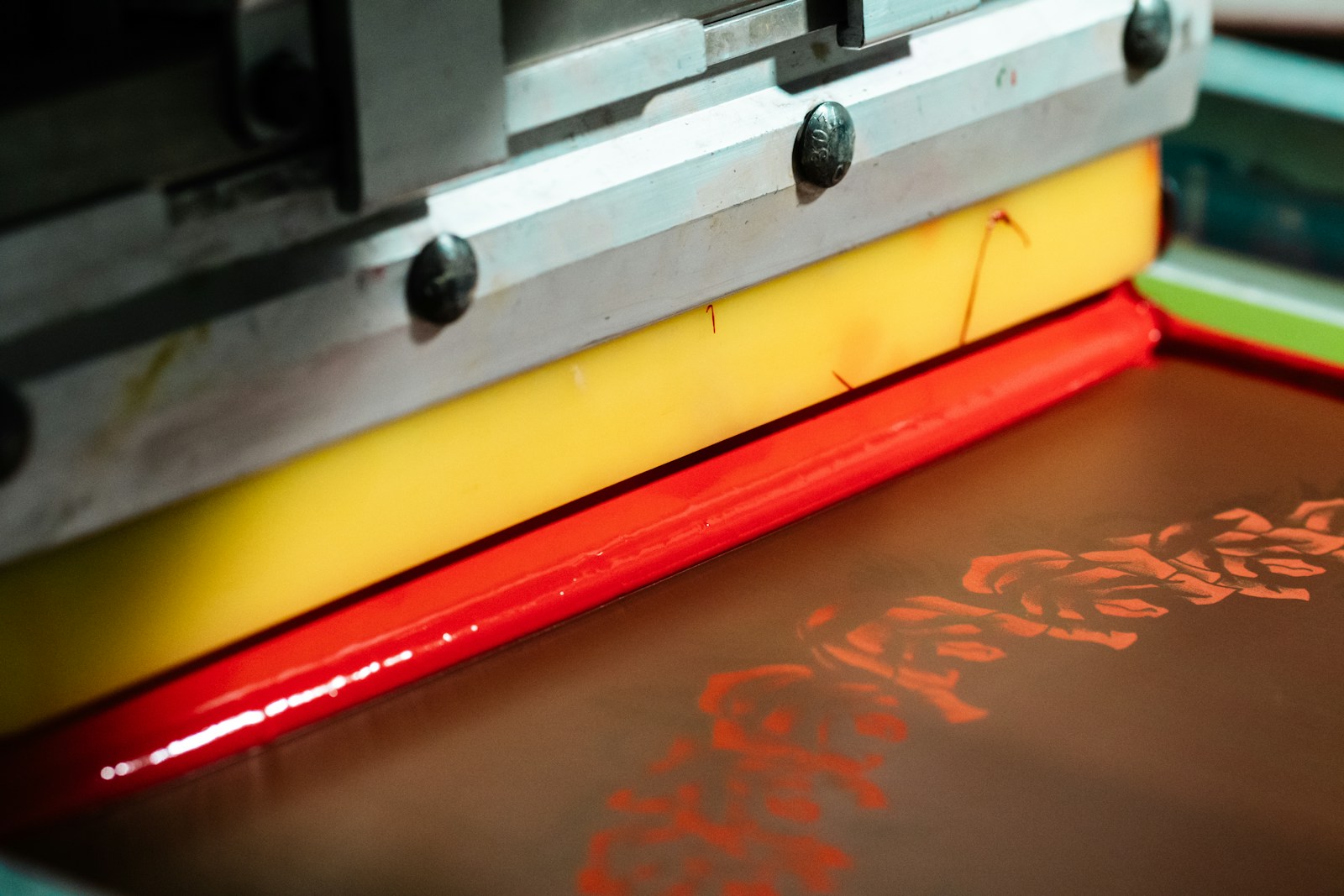Custom wedding tee coming off the screen printing press at a reception